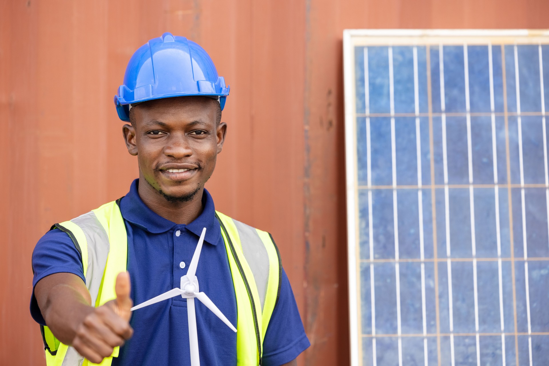 African American Industrial, factory and energy engineer Specialist. Portrait black man engineering holding windmill model container and solar cell on background